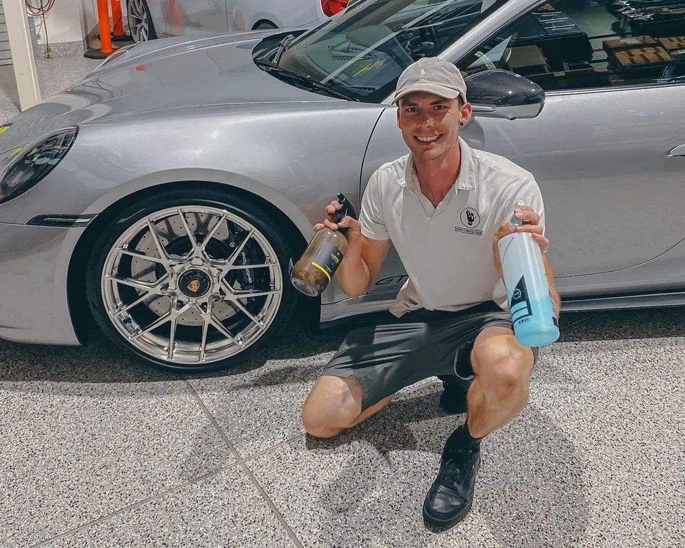 Ethan O'Keefe with a client's Porsche · O'Keefe's Prestige Detailing